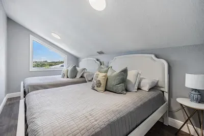 Bedroom 7 features 2 full beds with cozy linens, soft lighting, and a peaceful atmosphere. A versatile space ideal for kids, friends, or extra guests—offering both comfort and style with charming touches throughout.