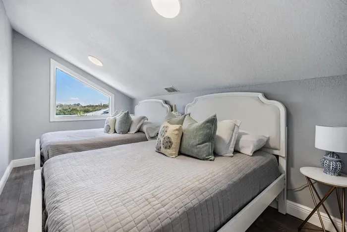 Bedroom 7 features 2 full beds with cozy linens, soft lighting, and a peaceful atmosphere. A versatile space ideal for kids, friends, or extra guests—offering both comfort and style with charming touches throughout.