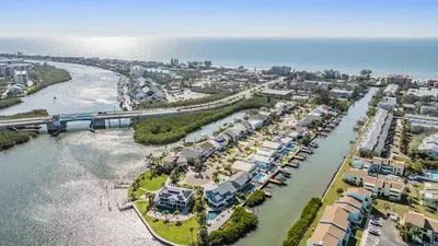 Nestled on a serene canal just steps from the Gulf, this home offers stunning water views, private dock access, and close proximity to beaches, dining, and attractions. The perfect blend of relaxation & convenience!