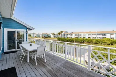 Spacious balcony with dining area overlooking serene water views. Perfect for enjoying morning coffee, family meals, or evening cocktails while soaking in the fresh coastal breeze and relaxing atmosphere.