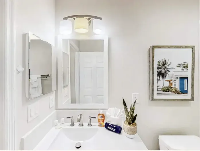 Bright and spotless bathroom with modern fixtures, elegant lighting, and beach-inspired décor. A perfect blend of style and comfort for a refreshing start or a relaxing end to your day.