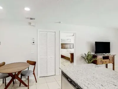 Bright, open layout with a cozy dining nook and modern kitchen leading to a relaxing living area. Perfect for shared meals or movie nights, offering comfort and style in every corner.