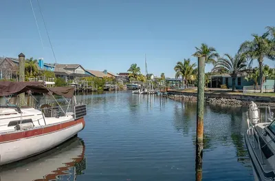 Peaceful canal lined with palm trees, offering a true taste of coastal living. Enjoy tranquil water views, gentle breezes, and the perfect spot to unwind or launch your next adventure.