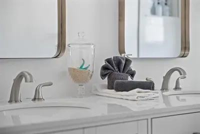 Spa-inspired double vanity with modern fixtures and a clean, elegant design.  Enjoy plenty of counter space, bright lighting, and thoughtful touches for a comfortable stay.