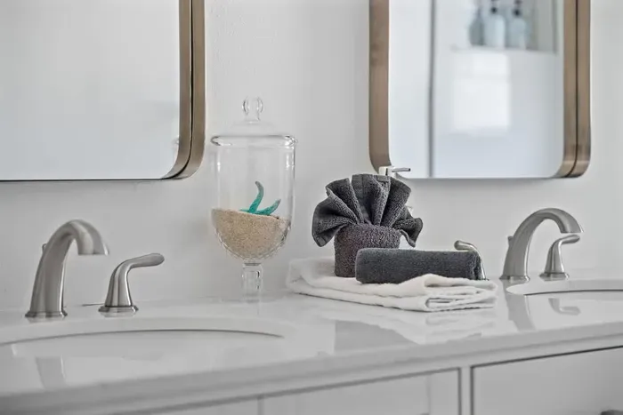 Spa-inspired double vanity with modern fixtures and a clean, elegant design.  Enjoy plenty of counter space, bright lighting, and thoughtful touches for a comfortable stay.