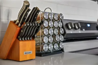 Thoughtfully equipped for home chefs! This kitchen features a complete knife set and organized spice rack, adding style and convenience to meal prep. Enjoy a clean, modern cooking space where everything you need is right at your fingertips.