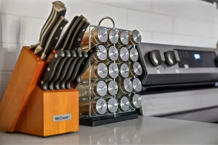 Thoughtfully equipped for home chefs! This kitchen features a complete knife set and organized spice rack, adding style and convenience to meal prep. Enjoy a clean, modern cooking space where everything you need is right at your fingertips.