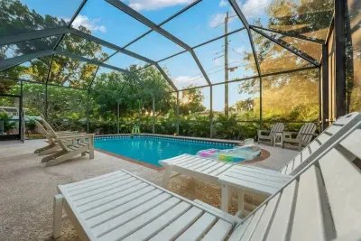 Unwind in your own private screened-in pool paradise! Stretch out on lounge chairs, soak up the sunshine, and enjoy peaceful tropical views all around.