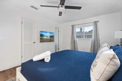 Spacious king bedroom designed for comfort and rest! Enjoy a plush bed with fresh linens, ceiling fan and soft natural light. Clean, bright, and inviting—your perfect private retreat after a full day of fun.