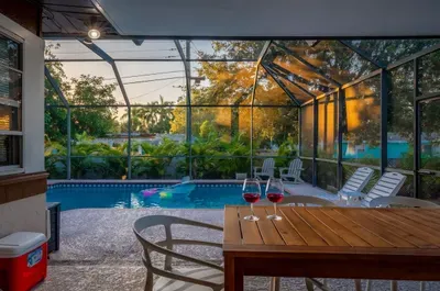 Unwind in this stunning screened-in pool retreat! Enjoy sunset views, a spacious outdoor dining area, cozy lounge seating, and a sparkling pool just steps away. Perfect for entertaining, morning coffee, or evening swims in total privacy and comfort.