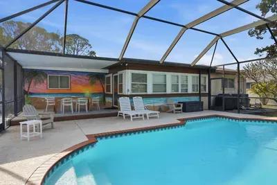 Soak up the sun on lounge chairs, enjoy colorful tropical murals, and relax in a spacious lanai designed for effortless indoor-outdoor living. The perfect backdrop for sunny days and unforgettable nights.