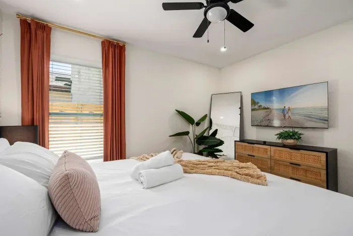 Unwind in this bright and inviting bedroom featuring a plush king bed, calming coastal décor, and stylish modern furnishings. Soft natural light and thoughtful design create the perfect relaxing retreat for peaceful nights and restful mornings.