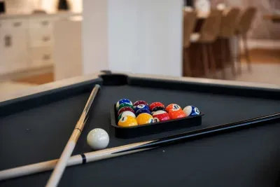 Rack up some fun in this stylish game room featuring a sleek pool table and plenty of space to unwind. Perfect for friendly competition, evening entertainment, or relaxing with family and friends after a day in the sun.