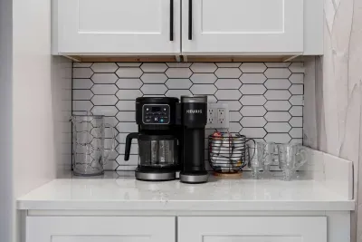 Enjoy a dedicated coffee bar stocked for easy mornings and relaxing evenings. Featuring a Keurig machine, stylish finishes, and all the essentials for your favorite brew, this cozy setup adds a perfect touch of comfort to your stay.