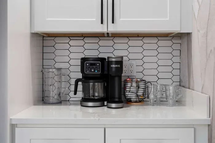 Enjoy a dedicated coffee bar stocked for easy mornings and relaxing evenings. Featuring a Keurig machine, stylish finishes, and all the essentials for your favorite brew, this cozy setup adds a perfect touch of comfort to your stay.