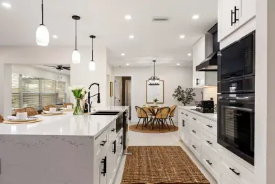 Cook and entertain with ease in this stunning modern kitchen featuring sleek quartz countertops, double ovens, spacious prep areas, and stylish lighting. The open layout flows perfectly for group gatherings, family meals, and relaxed vacation living.