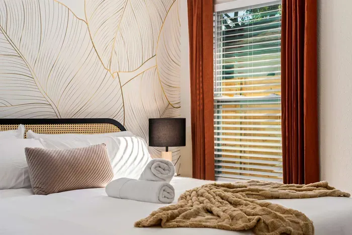 Relax in this beautifully styled bedroom featuring elegant botanical wall art, soft natural light, and cozy modern touches. Thoughtfully designed for comfort and tranquility, it’s the perfect retreat for restful nights and peaceful mornings.