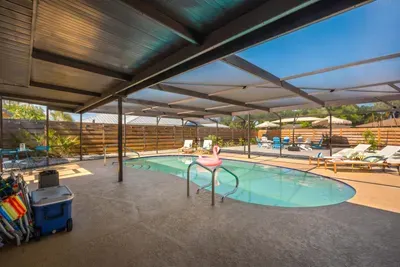 Enjoy endless outdoor fun in this expansive screened-in pool area featuring crystal-clear water, tropical surroundings, and plenty of space to lounge and relax.