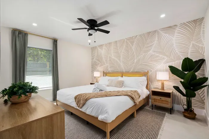 Unwind in this beautifully styled bedroom featuring a plush king bed, elegant tropical-inspired wallpaper, warm lighting, and calming décor. Designed for comfort and relaxation, it’s the perfect private retreat after a day of fun and adventure.