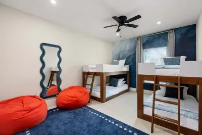 Perfect for kids and teens, this fun bunk room features cozy beds, playful bean bag seating, colorful décor, and plenty of space to relax and hang out. A stylish and comfortable retreat designed for sleepovers and unforgettable family vacations.
