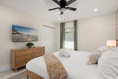 Rest easy in this bright and inviting bedroom featuring a plush king bed, calming coastal décor, and modern furnishings. With soft lighting and a peaceful atmosphere, it’s the perfect retreat for relaxing and recharging after a day of adventure.