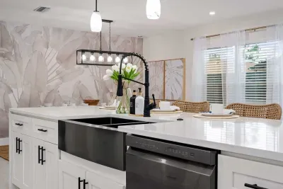 This bright and elegant kitchen island is the heart of the home, featuring sleek countertops, modern finishes, and plenty of space to gather. Enjoy casual breakfasts, evening drinks, or family meals in this stylish open-concept space.