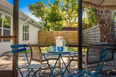 Sip your morning coffee or unwind in the evening in this charming outdoor patio space featuring cozy seating, tropical landscaping, and peaceful privacy. A perfect spot to relax, connect, and enjoy the beautiful vacation atmosphere.