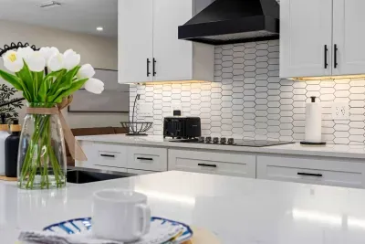 Start your mornings in this beautifully designed gourmet kitchen featuring sleek quartz countertops, modern finishes, and warm under-cabinet lighting. Perfect for coffee, cooking, and gathering with family and friends in style.