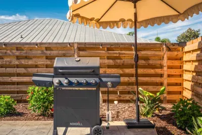 Fire up the grill and enjoy effortless outdoor cooking in this private backyard BBQ area featuring tropical landscaping, shaded seating, and sunny vacation vibes. Perfect for family cookouts, poolside meals, and relaxing evenings outdoors.