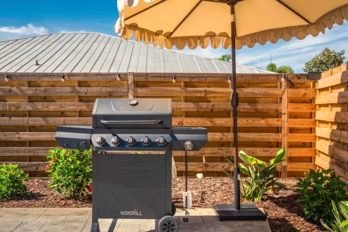 Fire up the grill and enjoy effortless outdoor cooking in this private backyard BBQ area featuring tropical landscaping, shaded seating, and sunny vacation vibes. Perfect for family cookouts, poolside meals, and relaxing evenings outdoors.