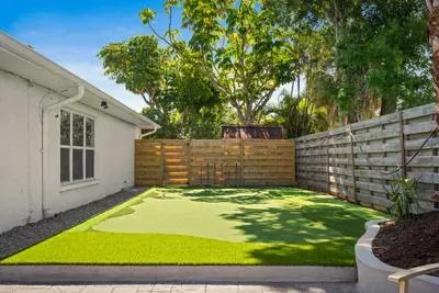 Enjoy your own private outdoor retreat with a spacious turf yard perfect for games, lounging, or letting the kids play freely. Surrounded by tropical greenery and privacy fencing, this sunny backyard is ideal for relaxing afternoons outdoors.