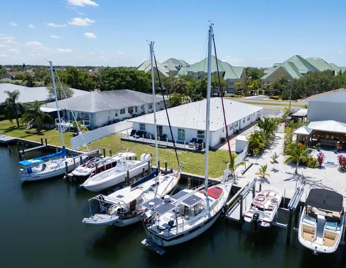 Waterfront getaway featuring scenic canal views. Ideal for boating enthusiasts or anyone seeking a peaceful coastal retreat surrounded by palm trees and blue skies.