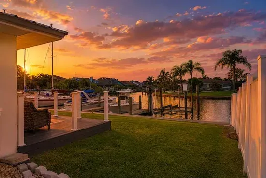 A canal-facing patio that catches every sunset. Palms silhouette the sky, sailboats settle across the water, and the evening unfolds at Gulf Coast pace.
