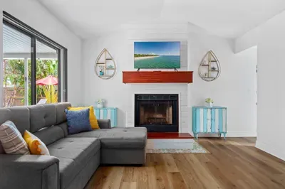 Step into this bright and airy coastal-themed living, where relaxation meets elegance. With its inviting decor, natural light, and beach-inspired accents, this space is perfect for unwinding or hosting gatherings with family and friends