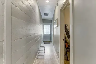 Long Hallway Adjacent to both bedrooms and leading to the front door. Shoe rack provided for easy access and storage of footwear