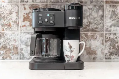 Start your morning right with this Keurig coffee station, offering both single-serve and carafe options. A thoughtful touch for guests who love fresh brews in a beautifully designed kitchen setting.
