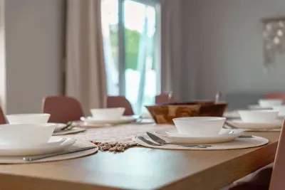 Elegant dining setup with soft natural light, blush seating, and a beautifully arranged table. Perfect for cozy breakfasts or evening dinners, this space invites guests to gather, relax, and enjoy every meal in style.