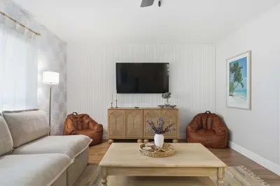 Relax in style in this chic living area featuring a smart TV, cozy bean bags, and warm wood accents. The perfect spot for movie nights or lounging with family—modern comfort meets effortless coastal charm.