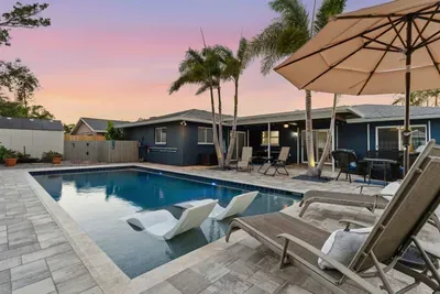 Unwind in this tropical backyard oasis featuring a sparkling pool, luxe loungers, and swaying palm trees. Perfect for sunset swims or lazy afternoons under the umbrella — your private paradise for ultimate relaxation and outdoor fun.