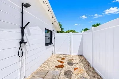 Private outdoor shower right off the pool gate — rinse the beach off before you step back into the house.
