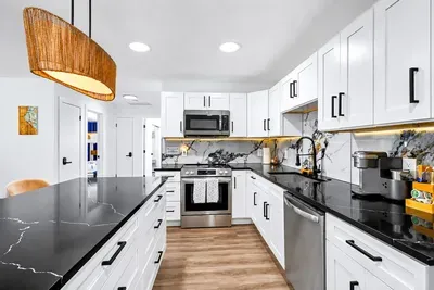 Full-length prep counter, dedicated coffee bar stocked with K-cups, under-cabinet lighting, deep sink for the big pans — the kitchen actually works when you're cooking for ten.