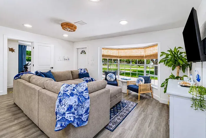 The whole family fits on the sectional, the TV settles the "what are we watching" argument, and the bay-window nook is for whoever needs a quiet ten minutes.