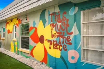 Vibrant exterior mural sets the tone for your stay—colorful, fun, and full of beachy personality. This playful backdrop makes every arrival photo-worthy and instantly lets you know you’ve found the place to relax.