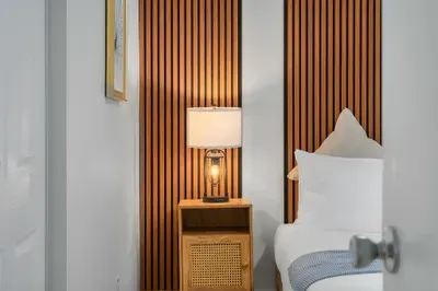 Thoughtfully designed bedroom details with warm wood accents, soft lighting, and plush linens. A cozy, calming retreat where comfort meets style—perfect for winding down and enjoying a restful night’s sleep.