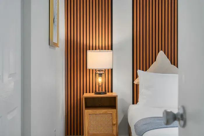 Thoughtfully designed bedroom details with warm wood accents, soft lighting, and plush linens. A cozy, calming retreat where comfort meets style—perfect for winding down and enjoying a restful night’s sleep.