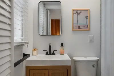 Bright, stylish bathroom with modern vanity, sleek fixtures, and thoughtful coastal touches. Clean lines and a calming design create a fresh, spa-like space to refresh and unwind.