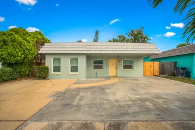 Charming beachside bungalow with bright curb appeal and easy driveway parking. This colorful coastal retreat welcomes you with relaxed vibes, private outdoor spaces, and the perfect home base for your sunny getaway.