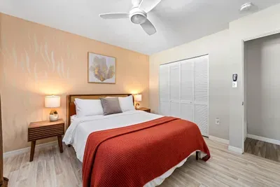 Bedroom with Queen bed and ceiling fan.