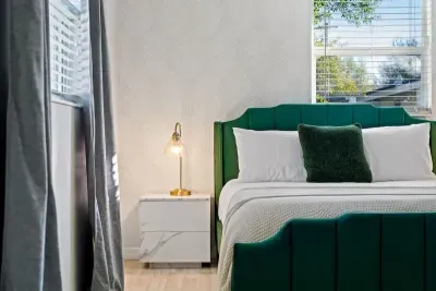 Bedroom with Queen bed, TV, and ensuite bathroom.