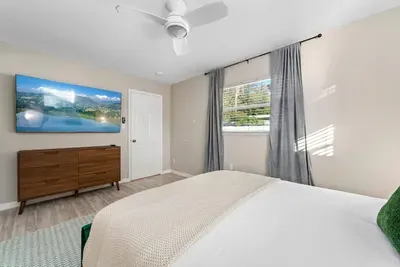 Bedroom with Queen bed, TV, and ensuite bathroom.